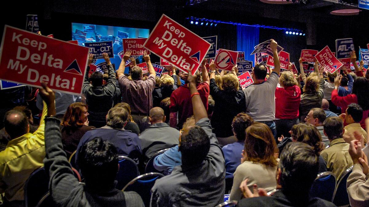 Delta employees and other hold up "Keep Delta My Delta" signs in support of the airline in 2006.