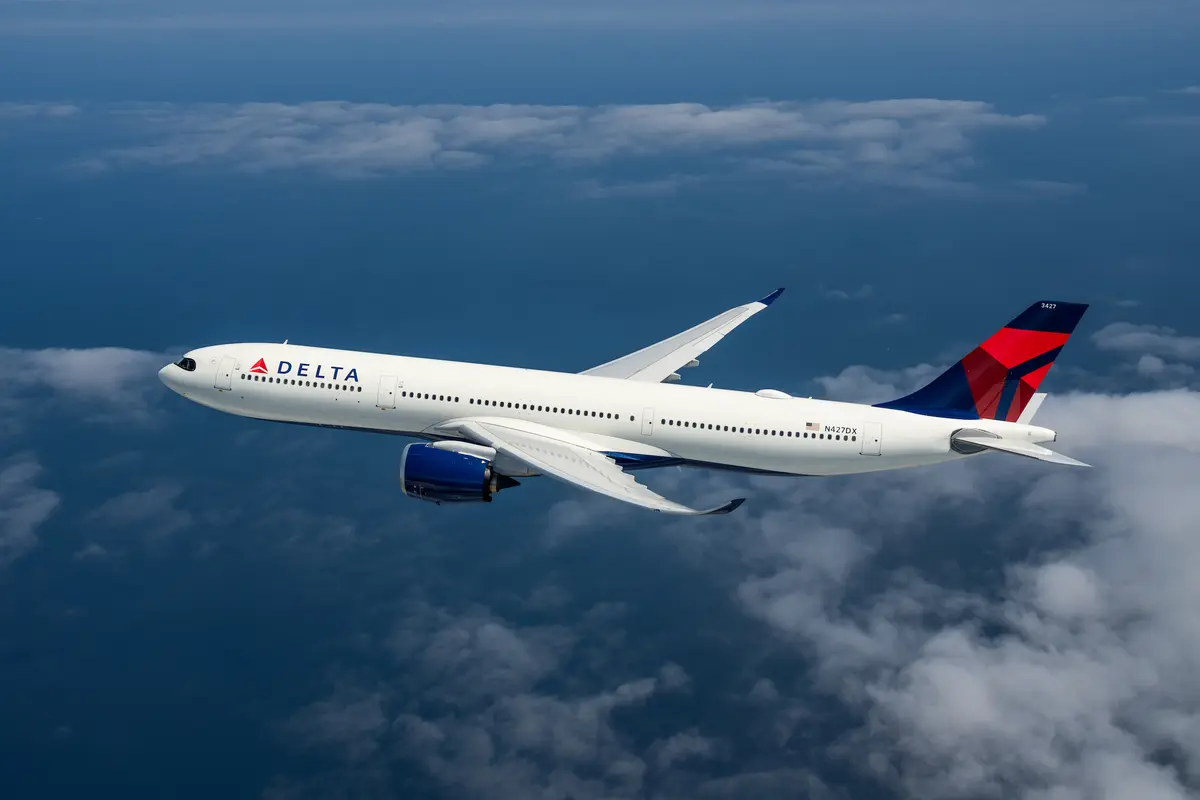 An A330-900 flying among clouds