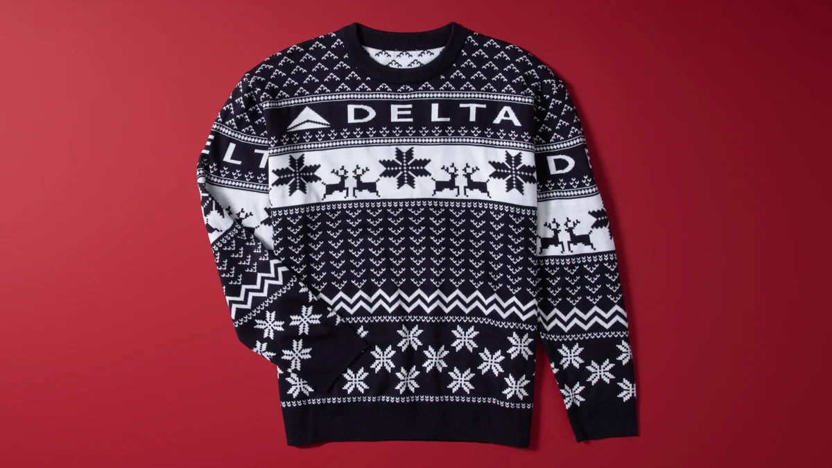 Show off your love for travel this winter with our Navy Delta Holiday Sweater. Cozy and colorful, this sweater is perfect for any festive occasion. 