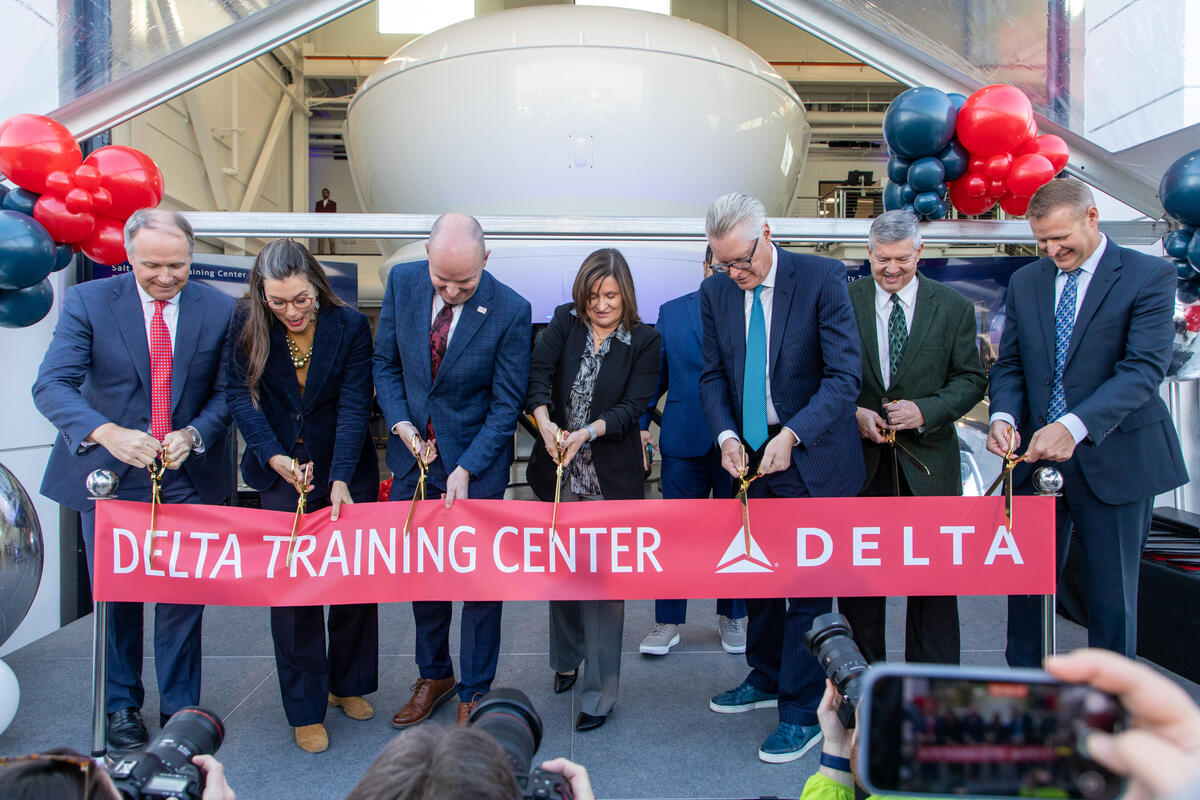 Delta leaders and Salt Lake City government officials cut the ribbon at the opening ceremony at Delta's new pilot training facility