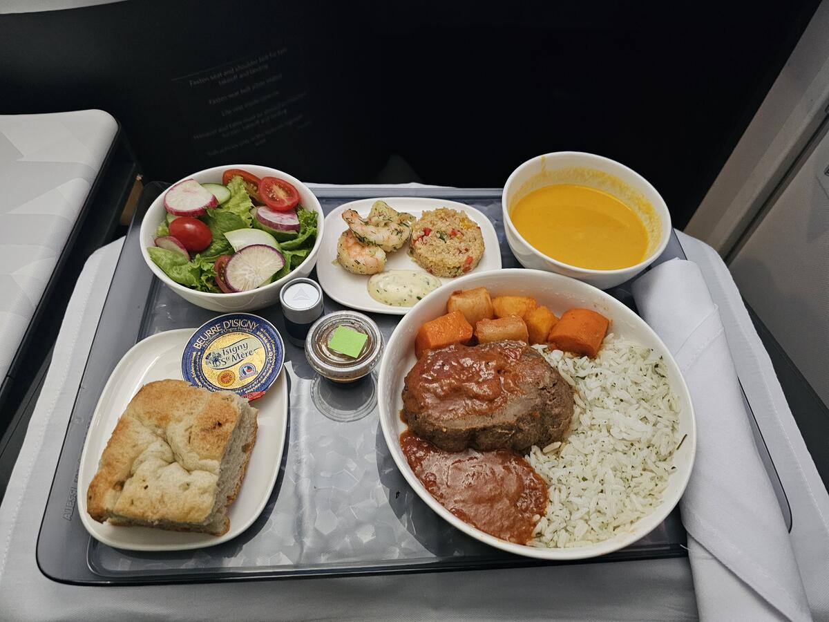 Braised beef with domoda sauce, steamed rice and roasted root vegetables.