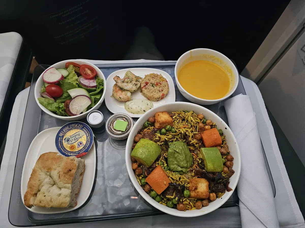 Vegetable curry, complemented with biryani rice, fried paneer, chickpeas and coriander.