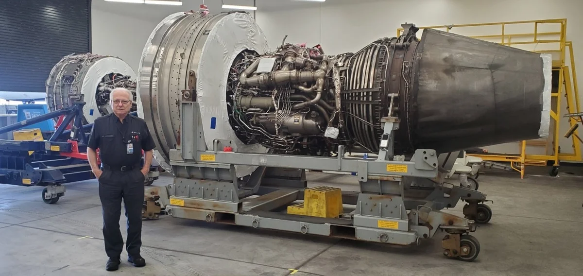 Jimmy posing in front of aircraft engine