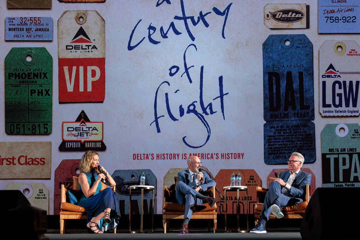 Journalist Brooke Baldwin, director & producer Joshua Seftel and Delta CEO Ed Bastian on stage discussing the film. 