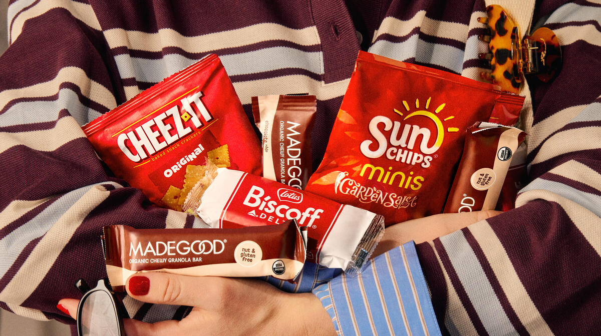 Someone holds an armful of snack served on Delta flights