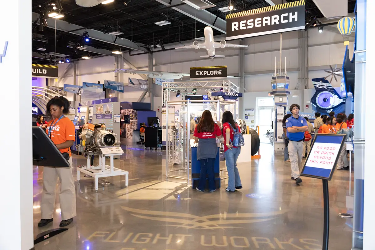 Students explore interactive aviation and aerospace exhibits at the Flight Works Alabama education center.