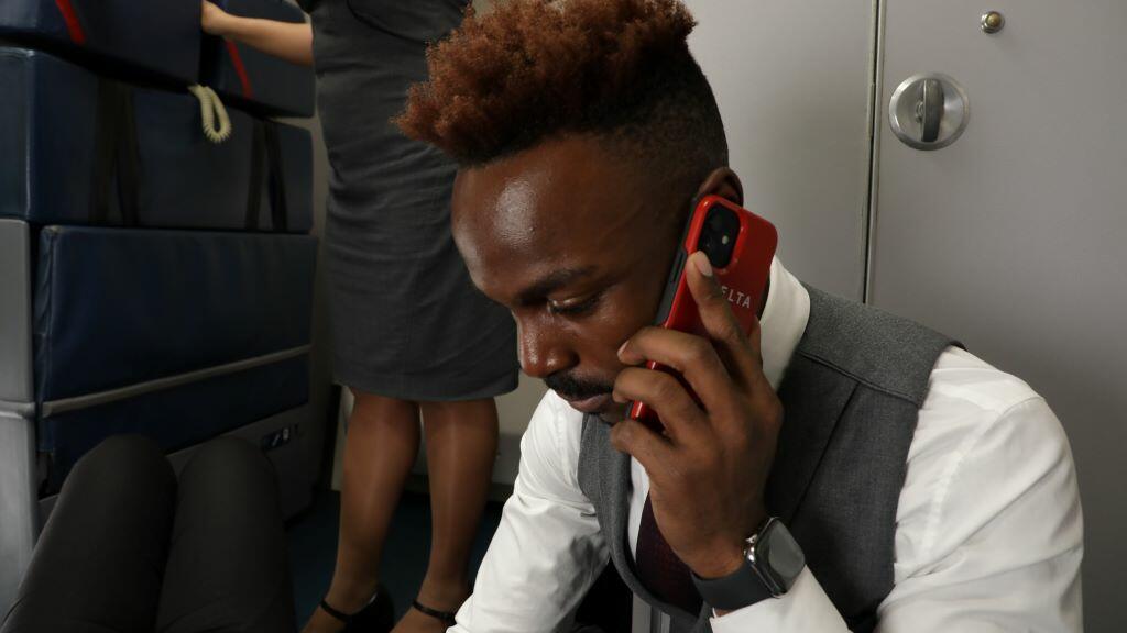 A Delta flight attendant speaks with a medical professional using their SkyPro mobile device.