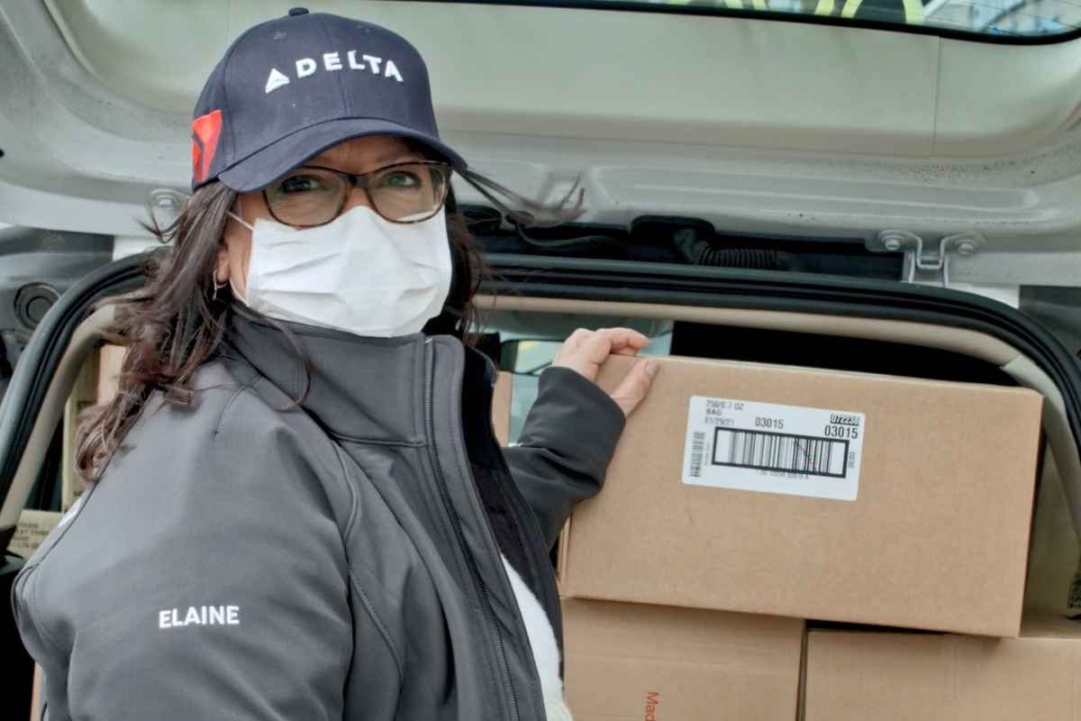 Delta employee donating items to charities