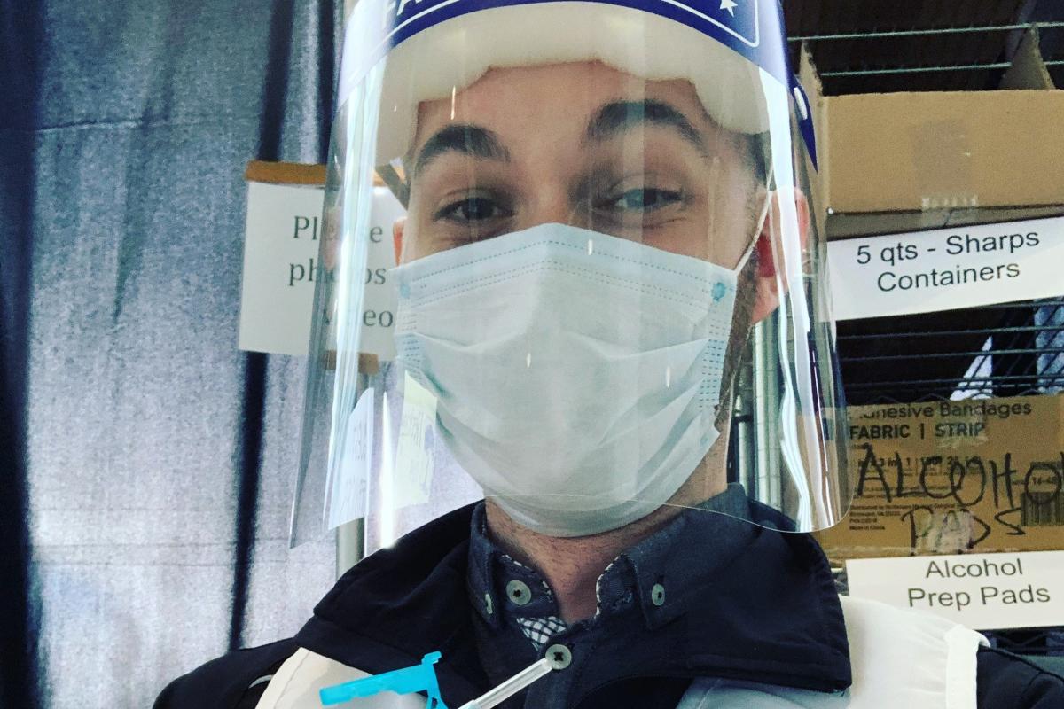 Delta employee wearing PPE as a vaccine provider in his community