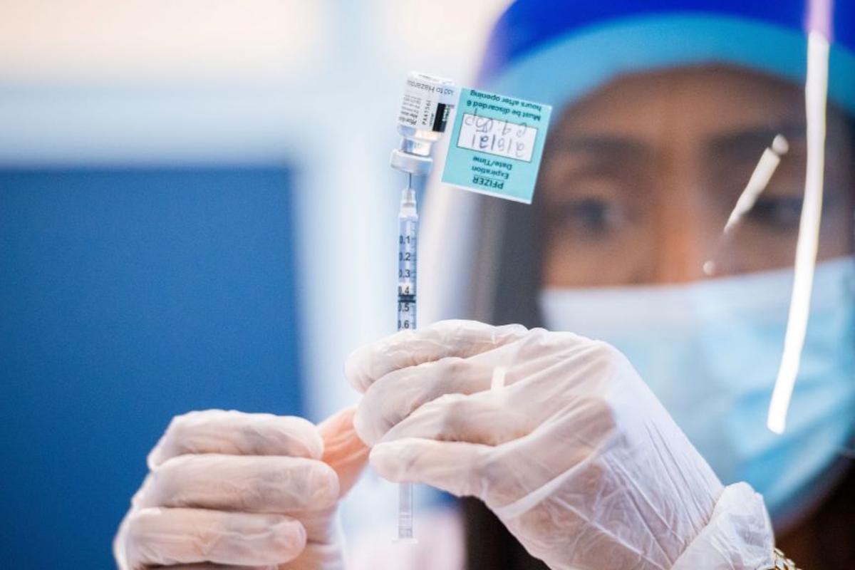 A medical worker prepares a COVID-19 vaccine dose.