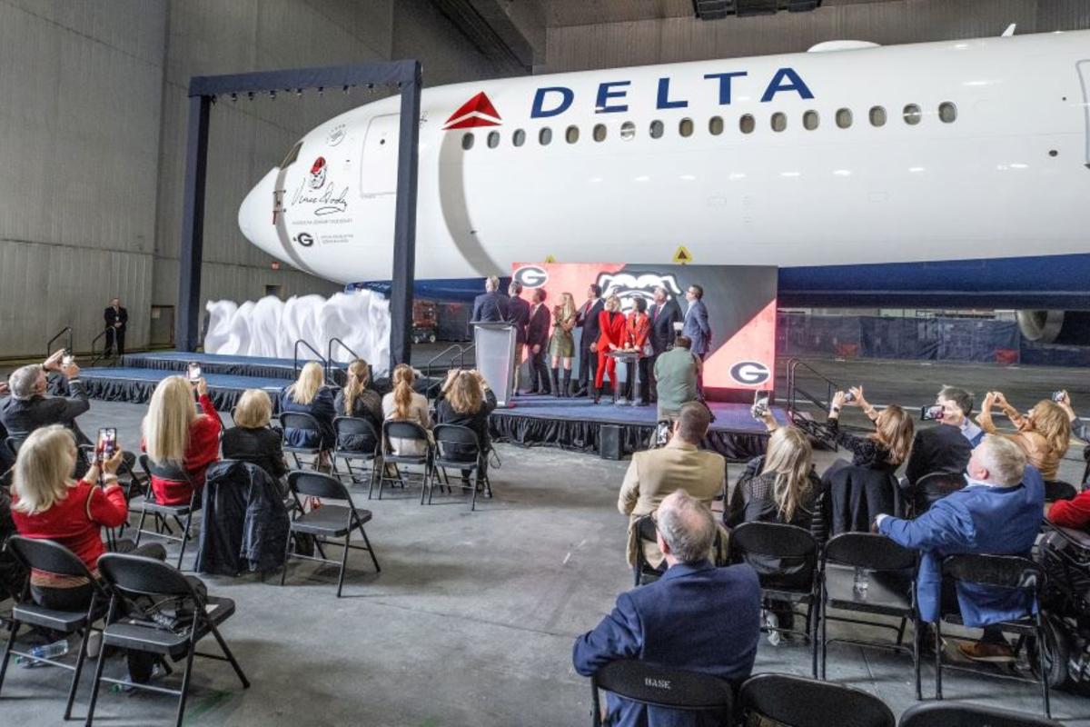 A curtain drops to reveal a memorial seal on a Delta Boeing 767-400 honoring renowned UGA football coach Vince Dooley.