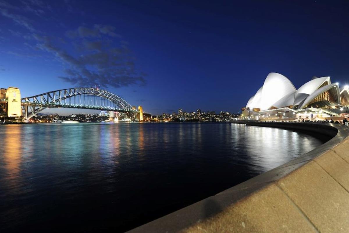 A nightime view of the Sydney Harbour Bridge and Sydney Opera House