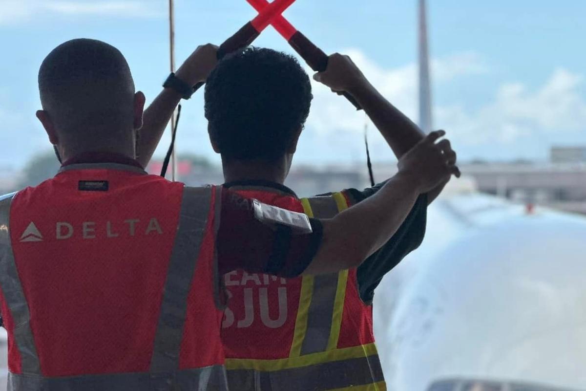 A Delta employee works with a child at San Juan Airport as part of a special initiative to inspire excitement about aviation.