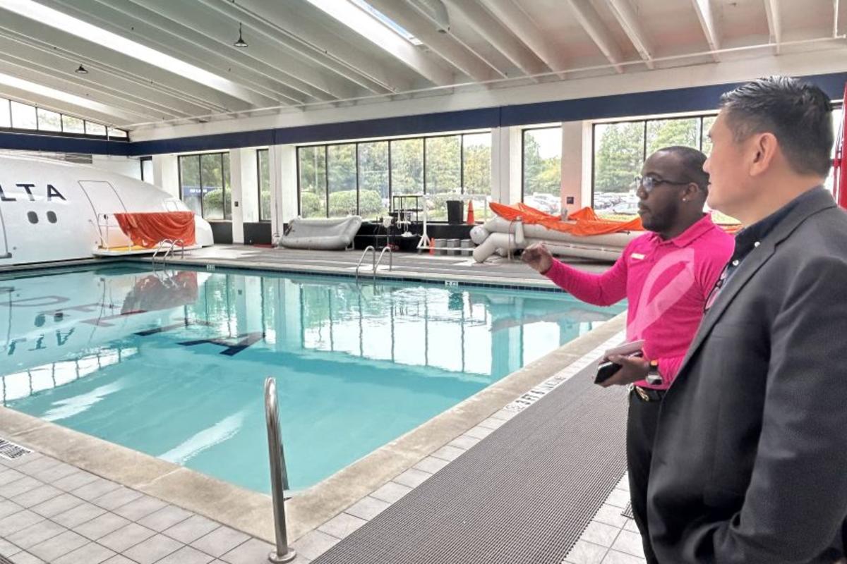 A Delta technical facilitator gives Todd O., Delta's most frequent flyer, greater insight into the rigorous flight attendant training sessions overlooking the emergency diving pool. 