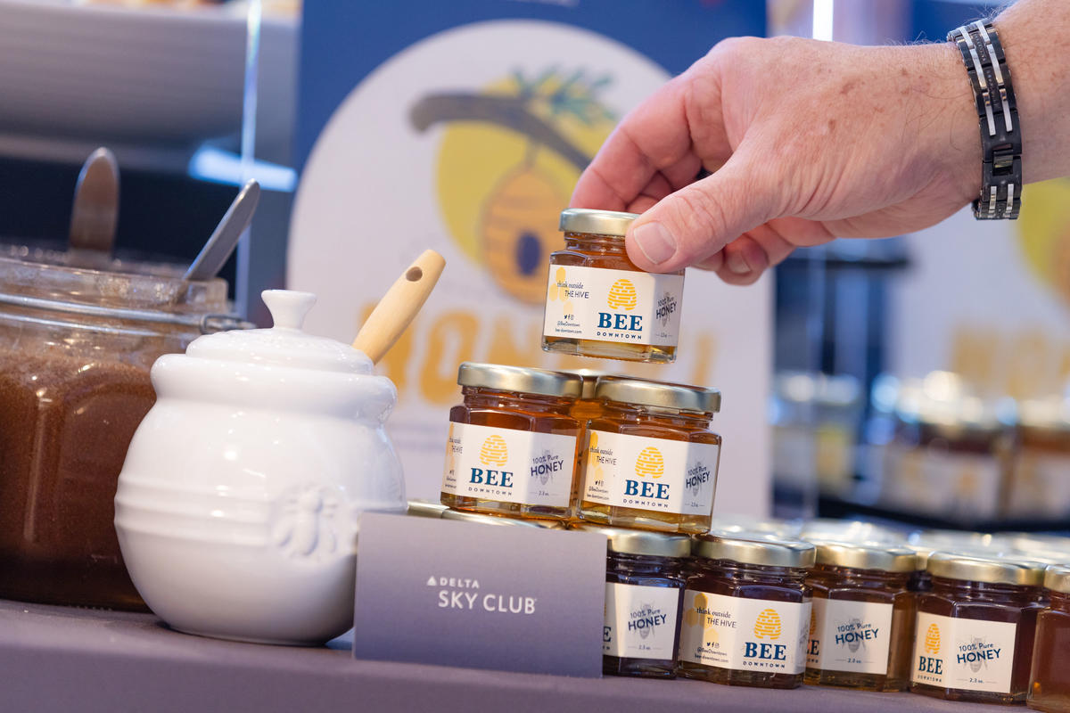 A stack of jars of local, metro Atlanta honey which were gifted to travelers as part of Delta's commitment to supporting the environment.