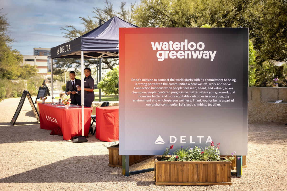 Delta Air Lines signage welcomes visitors to the pop-up market and mural unveiling event, in partnership with Future Front Texas and Waterloo Greenway on Sunday, March 10, at Meredith Heritage Tree Deck in Waterloo Park.