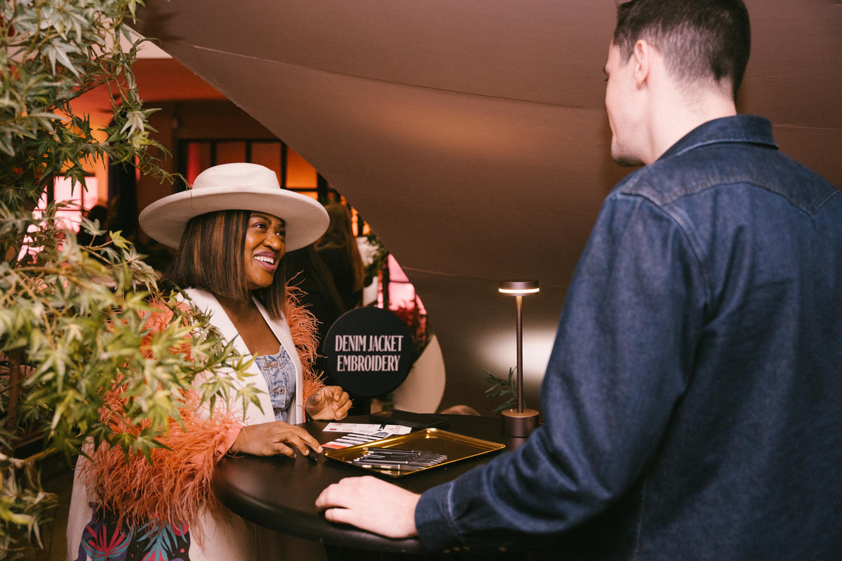 A SkyMiles member checks into the Denim Jacket Embroidery Station at Delta's SXSW lounge. 