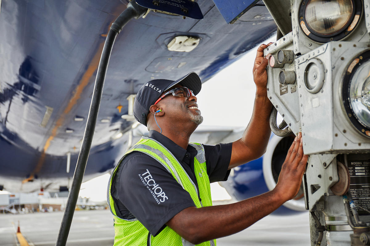 A Delta TechOps employee works on an aircraft