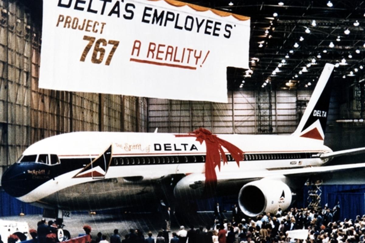 The Spirit of Delta plane sits below a large "Project 767" banner.
