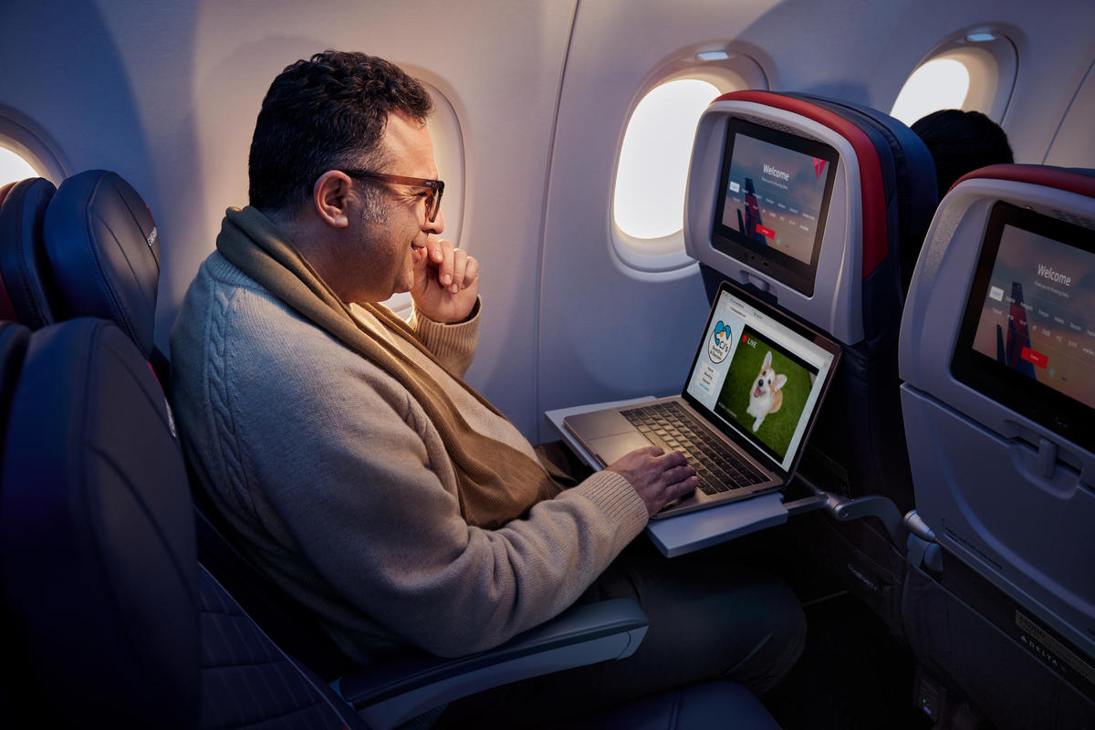 A customer enjoys surfing the web using Delta's fast, free Wi-Fi powered by T-Mobile.