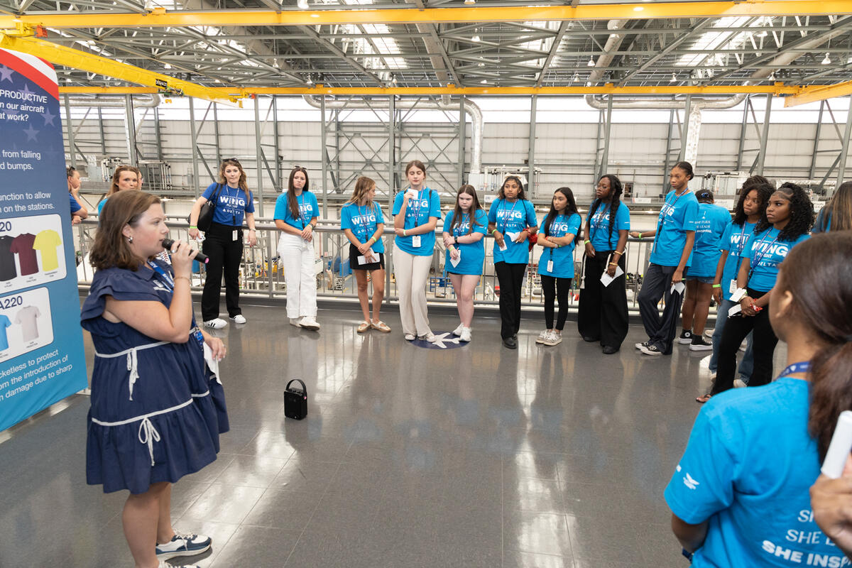 Students gather for a guided tour overlooking the Airbus aircraft manufacturing facility.