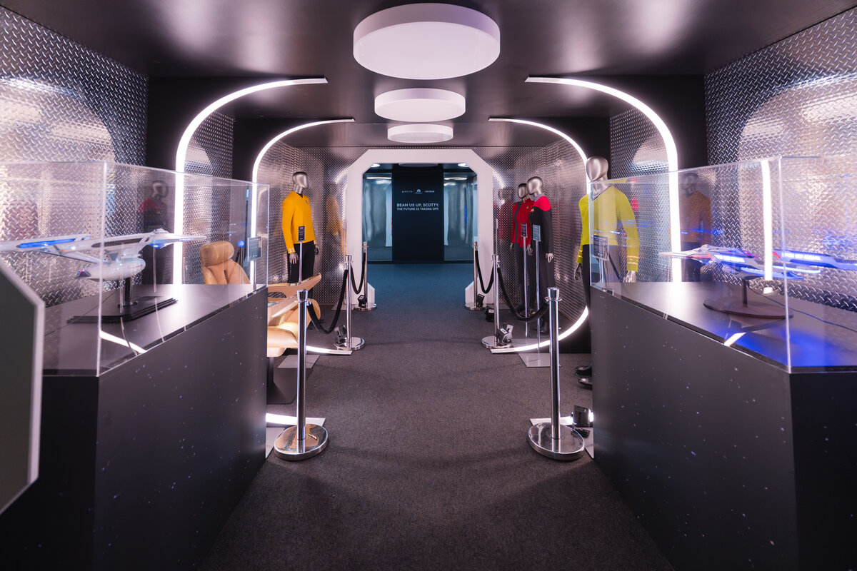Star Trek-themed exhibit featuring model starships, uniforms and immersive lighting displays.