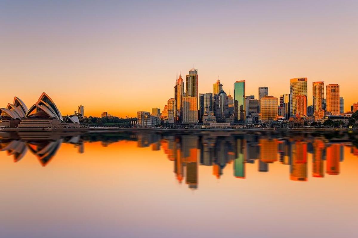 A view of downtown Sydney and the Opera House against a sunrise