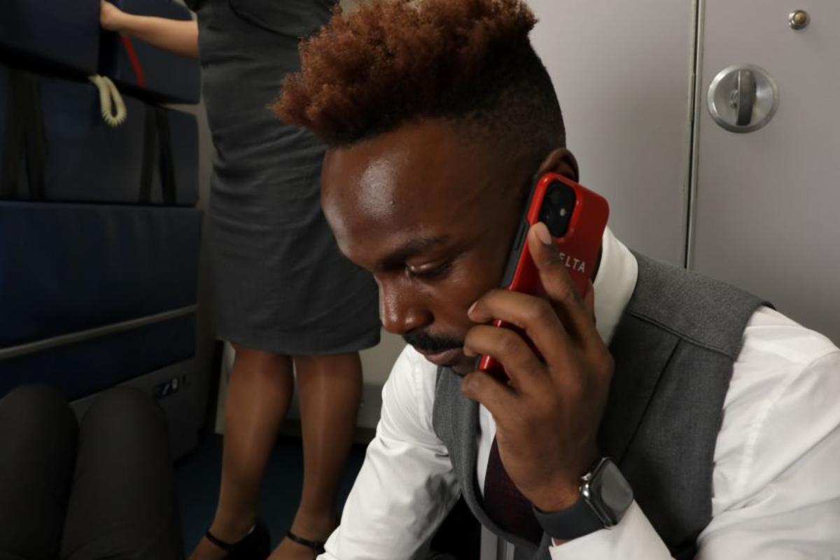 A Delta flight attendant speaks with a medical professional using their SkyPro mobile device.