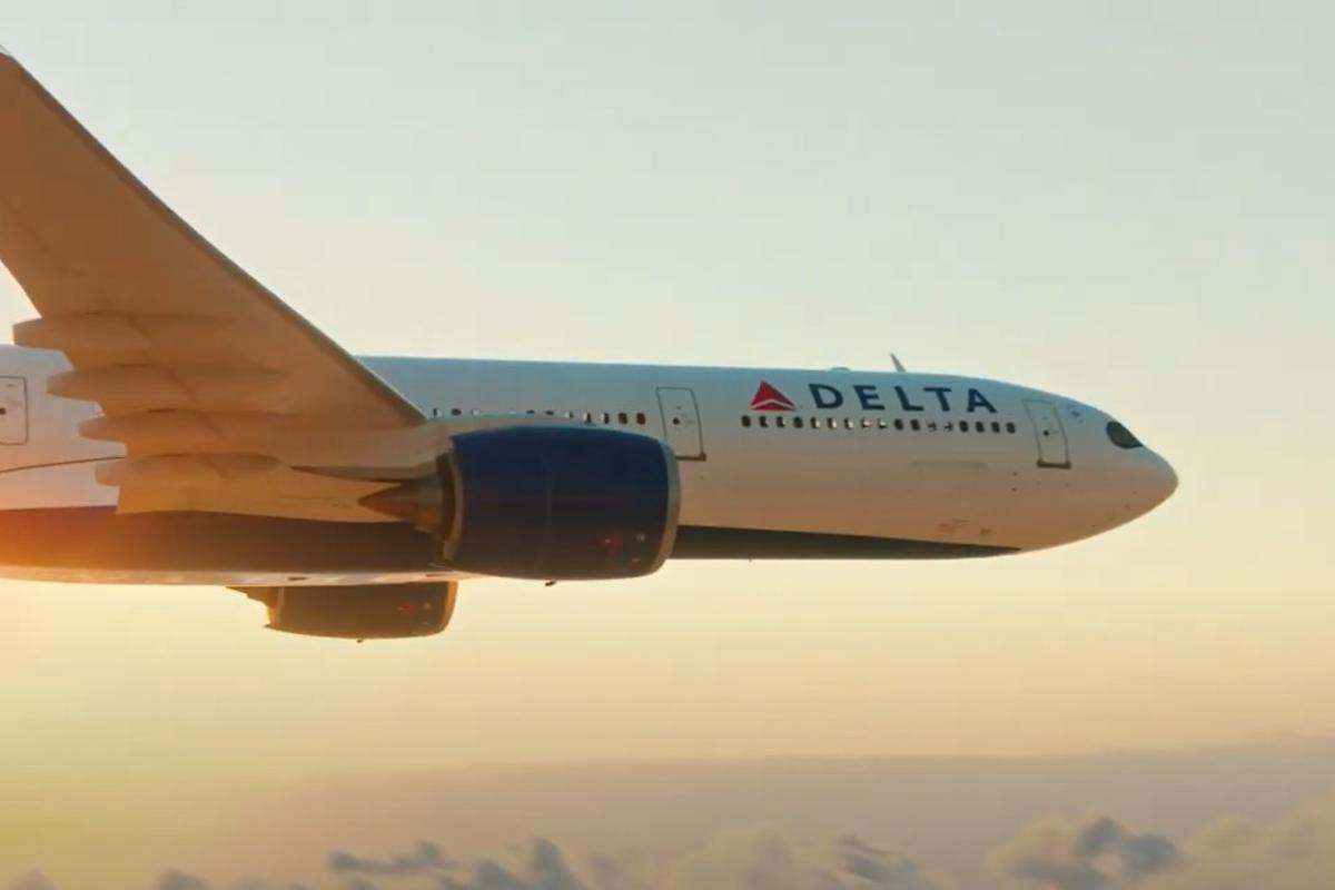 A still of a Delta plane flying against a sunset for Delta's "To See Beyond, Go Up" South America marketing campaign
