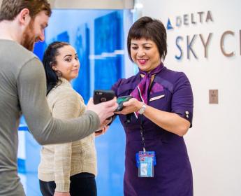 Employee with customers at Delta Sky Club