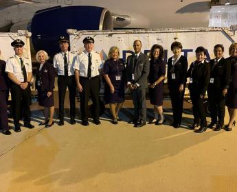 Capt. Thomas Pelczynski and Joan Crandall with the entire flight crew.