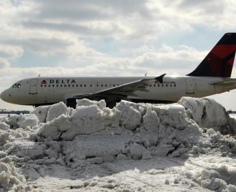 A319 moving safely past a mound of snow