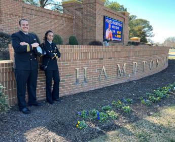 Two aviators stand outside of Hampton University.
