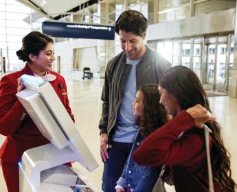 A family checks in with the help of a famous Delta Red Coat.