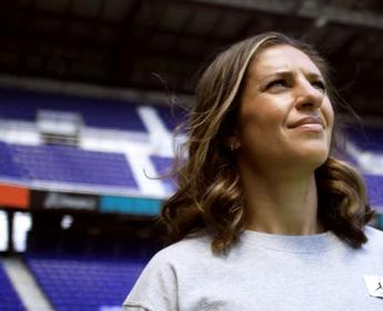 Close up of soccer legend Carli Lloyd standing in a soccer stadium