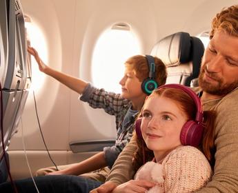 Delta customers enjoying in-flight entertainment