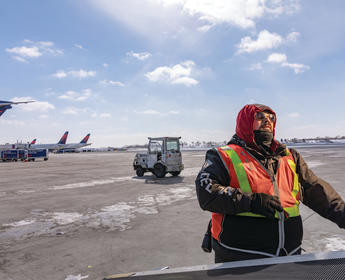 A Delta Aircraft Load Agent works in winter conditions at Minneapolis-St. Paul International Airport (MSP).