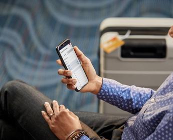 A Delta customer uses the Fly Delta app to view their flight.