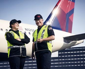 Delta TechOps employees standing in front of an aircraft