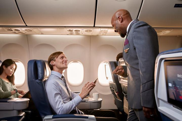 Flight attendant helping customer on board